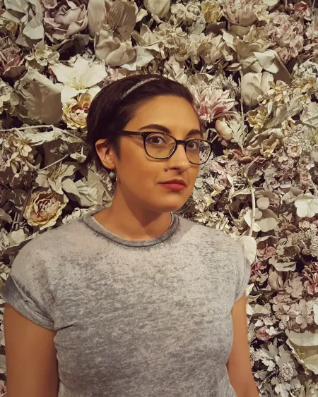 Natasha in front of a floral background