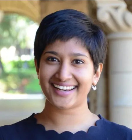 Nushelle de Silva in front of a stone archway.