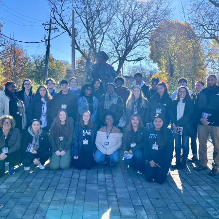 Group of 25 participants in front of the Harriet Tubman statue.