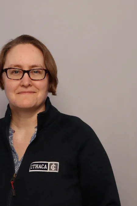 Headshot image of Jenny Pickett on grey background.