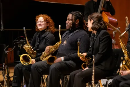 Students in a jazz ensemble with saxophones.
