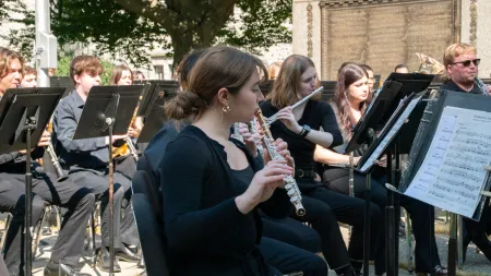 Student musicians at an outdoor wind ensemble concert.