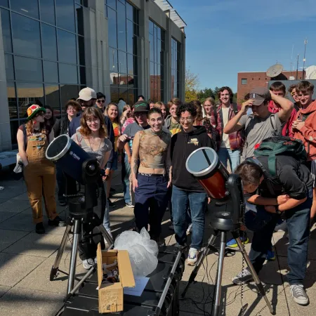 Students gather on the patio of CNS to view the sun's solar flares resulting from a geomagnetic storm.