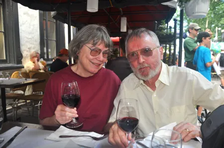 A woman and man enjoy wine.