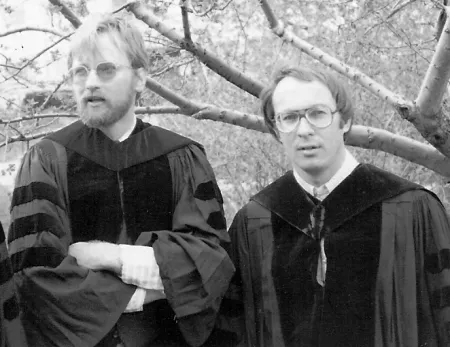 Two men wearing academic regalia in a black and white photo.