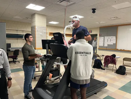 man running on treadmill, as his respiration is monitored