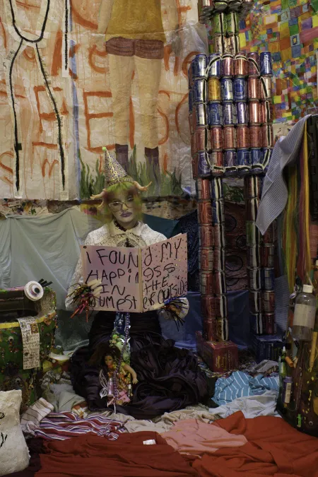 A student in theatrical make-up performs in their art show.