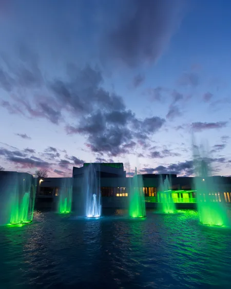Fountains lit with green. 