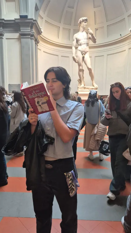 Student in Uffizi Gallery near statue of David.