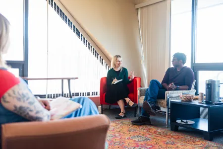 Faculty and student conversation in Muller Faculty Center Office