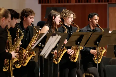 College students play saxophone in the Wind Ensemble. 