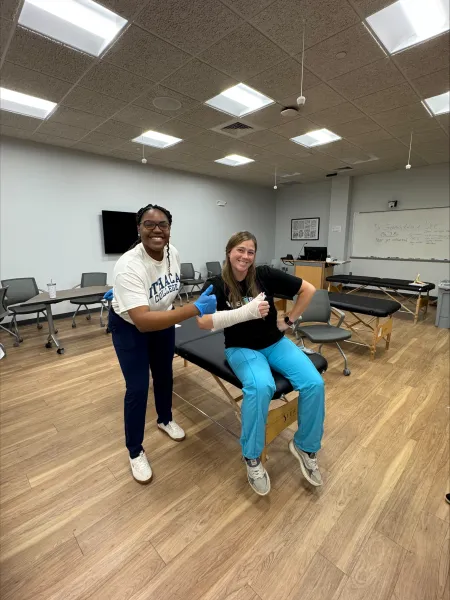 Joan Esmie MS '26 working with a client as she completes her degree.