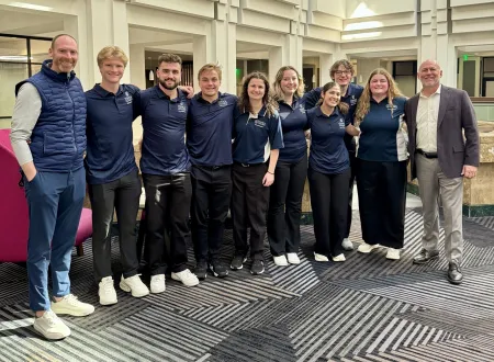 Students and alumni pose for a group photo.