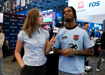 A college student interviews NFL star Damar Hamlin. 