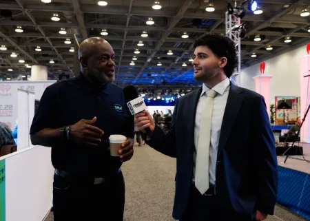 A college student interviews NFL legend Emmitt Smith.