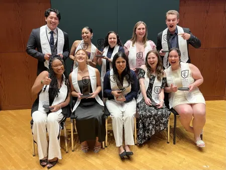 Group of 10 college students holding awards