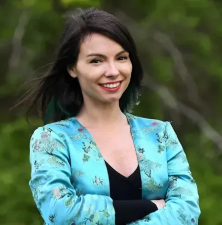 dark haired woman with flowery blue shirt