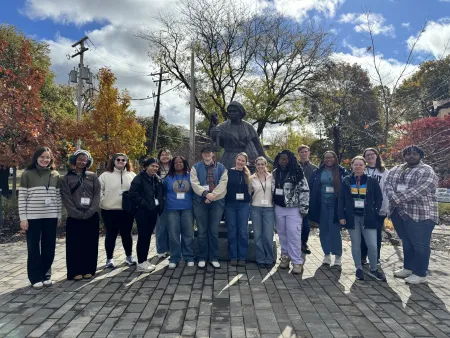 Group of 15 participants in front of the Harriet Tubman statue.