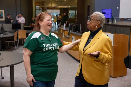 Two women laugh together. 
