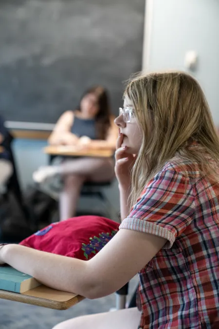 Student attentively listening to the conversation. 