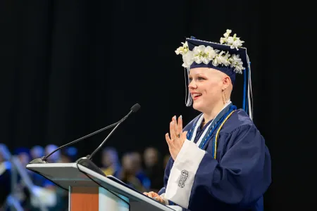 A student Commencement speaker at a podium.