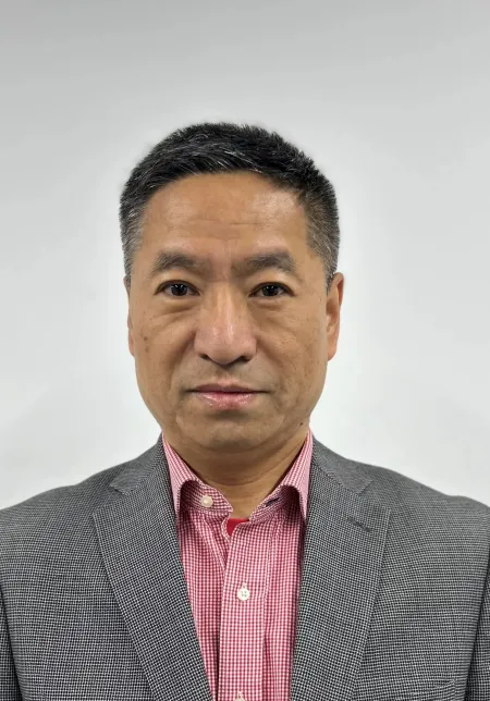 Man wearing a sport coat and pink shirt