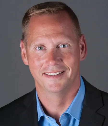 Man wearing a blue shirt and sport coat.