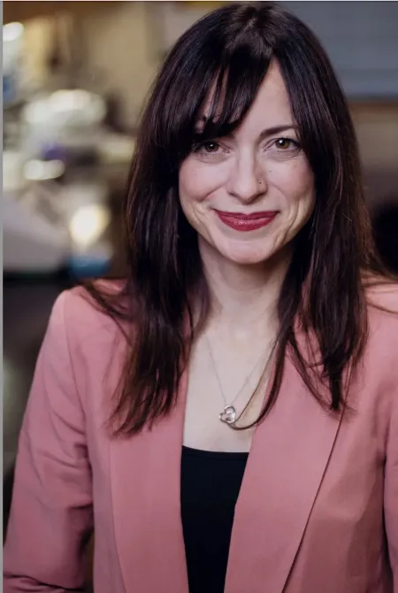Woman wearing a pink jacket.