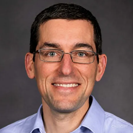 Man wearing glasses and a blue shirt.