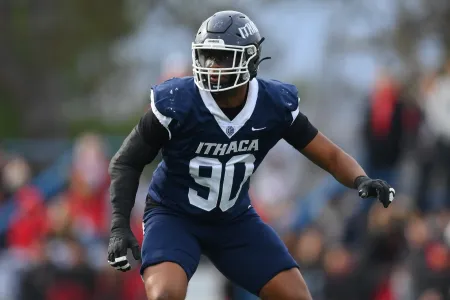 A college football player in blue uniform wearing #90