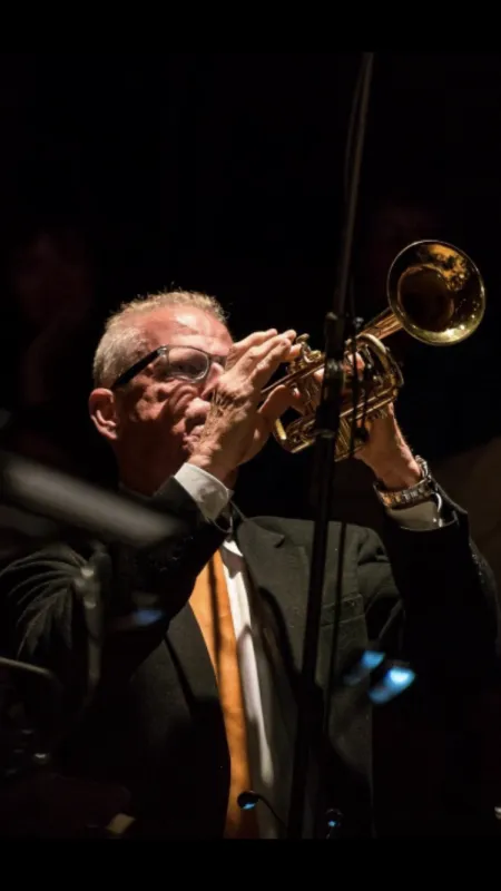 A man plays a trumpet.