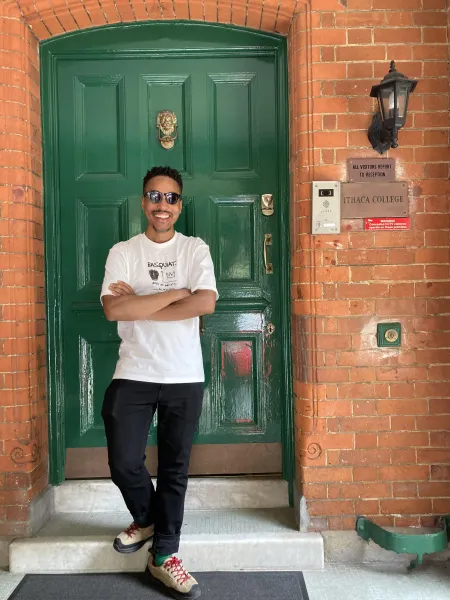 Ajamu Brown Standing in Front of a Door