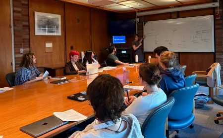 Students sit around a seminar table.