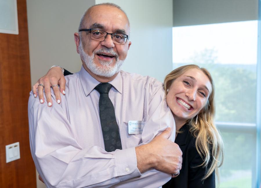 Professor posing with a student