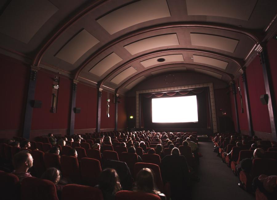 group of people watching a movie in a theatre