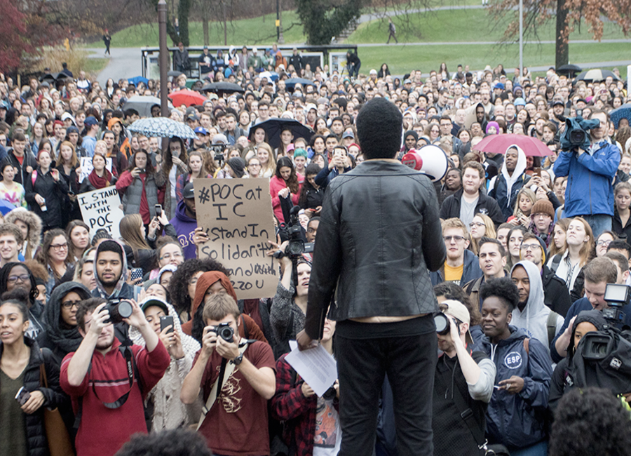 group of students assembled outside listening to a speaker