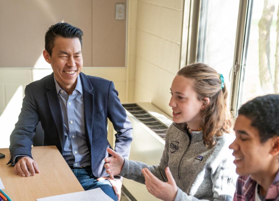 Jack Wang works with a group of students 