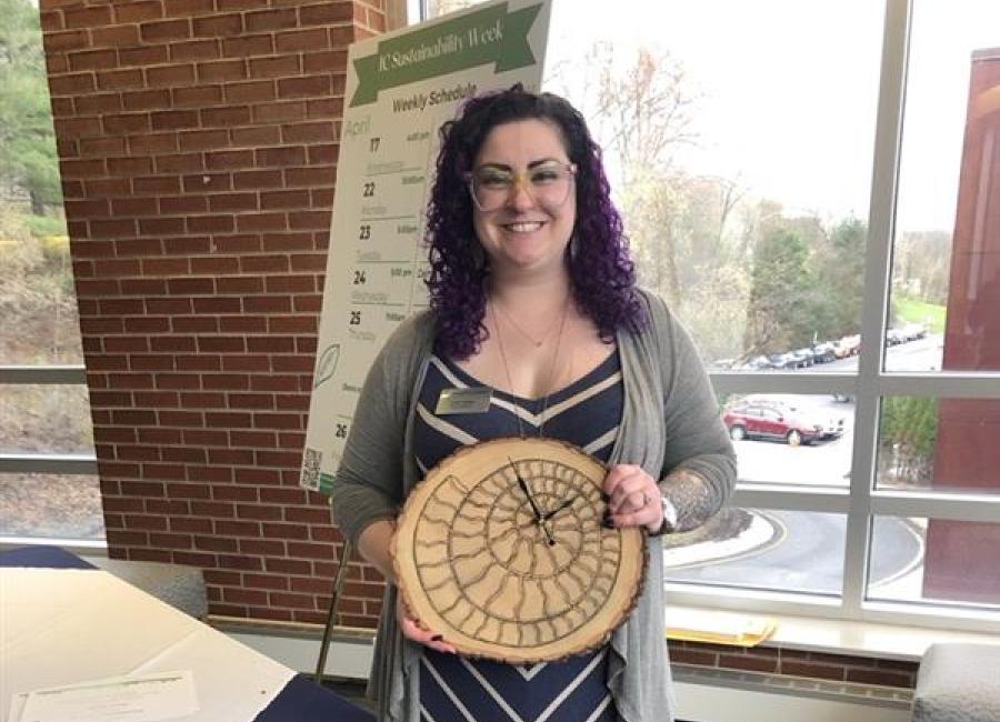 Crissi Dalfonzo stands holding her award.