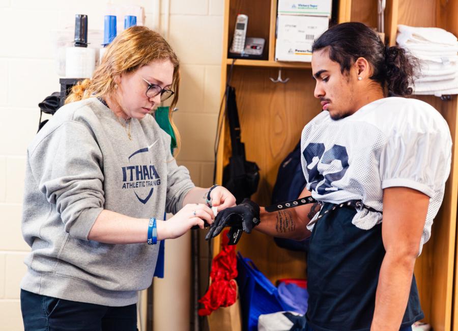 Physical therapy student assists a student-athlete.