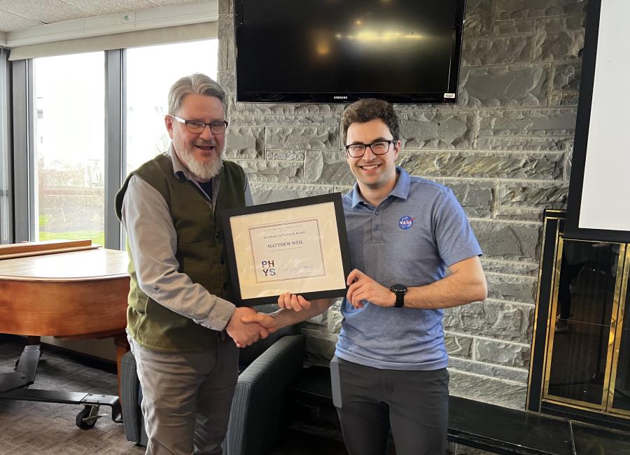 Matt Weil '24 receives an award from Professor Matt Price