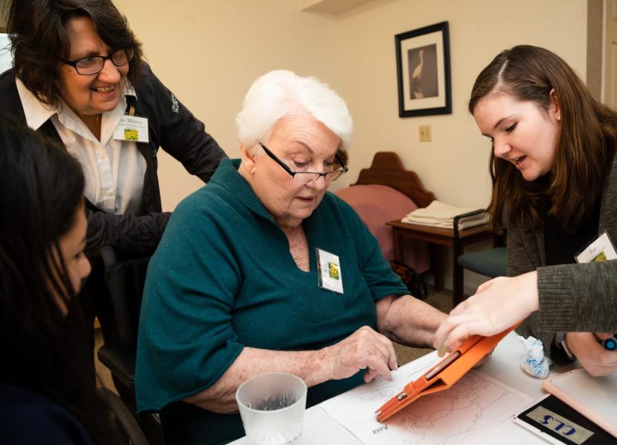 Ithaca College SLP grad student works with an elderly woman