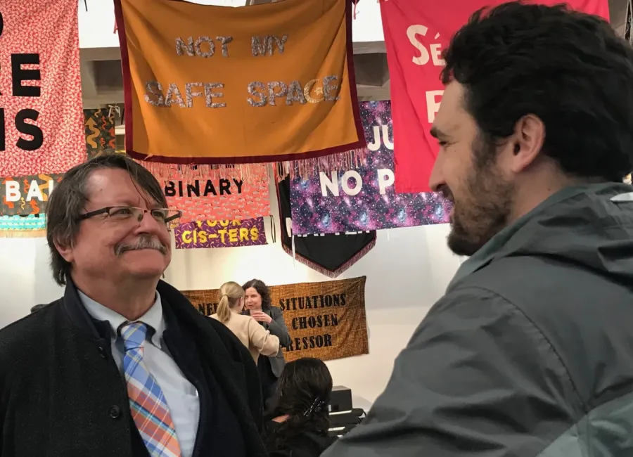 Professor Zenon Wasyliw chats with History alum David Kaminsky at our 2019 Spring History Celebration.  The banners were part of a show on protest banners at the Handwerker Gallery.