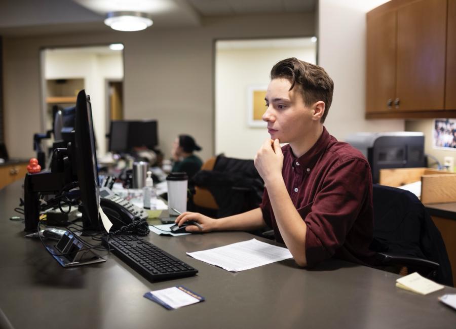 Student Employee assisting at Ithaca College's Information Desk