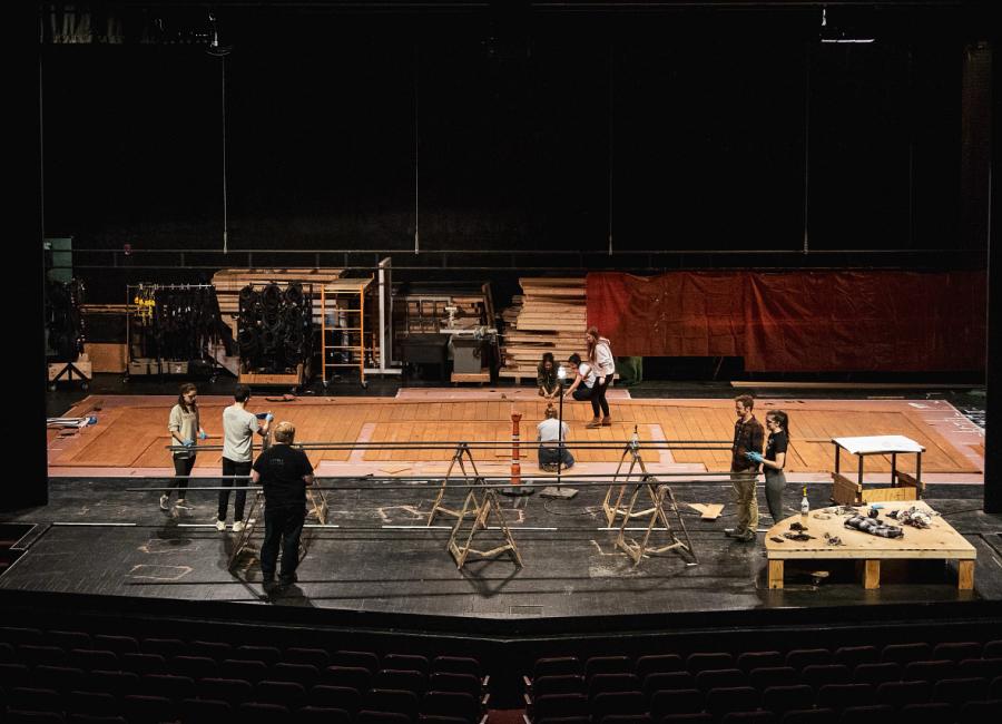 a group of theatre students setting up a stage