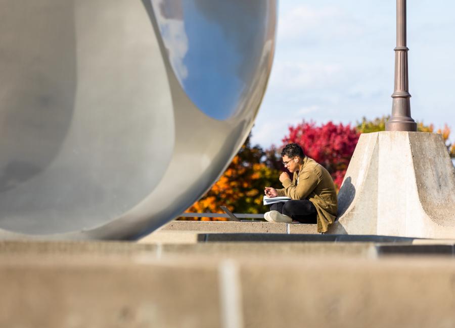 Student sits near Textor ball