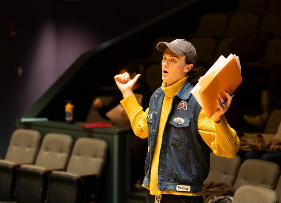 student standing in the seating area of a theatre