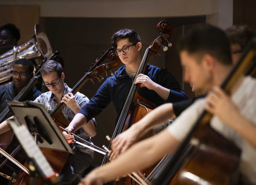 students rehearsing in symphony orchrstra