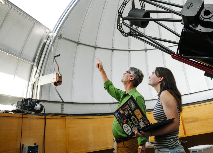 Professor Luke Keller and Lacey Dunn study astrophotography in the Clinton B Ford Observatory.