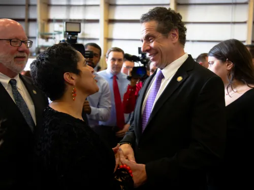 Shirley M. Collado speaking with and shaking hands with Andrew Cuomo