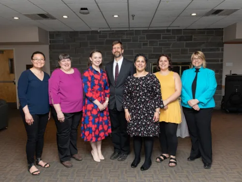 Seven people standing in a row for a photo